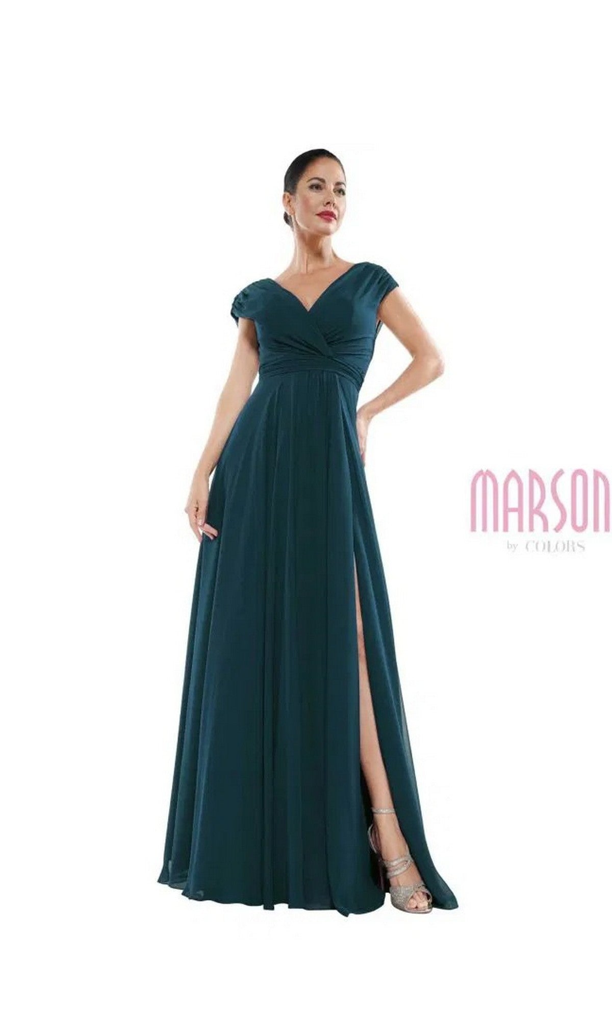 A woman poses with one hand on her hip in the Marsoni M251 long formal dress, a floor-length dark teal chiffon gown with short sleeves, a V-neckline, and a thigh-high slit, set against a white background.